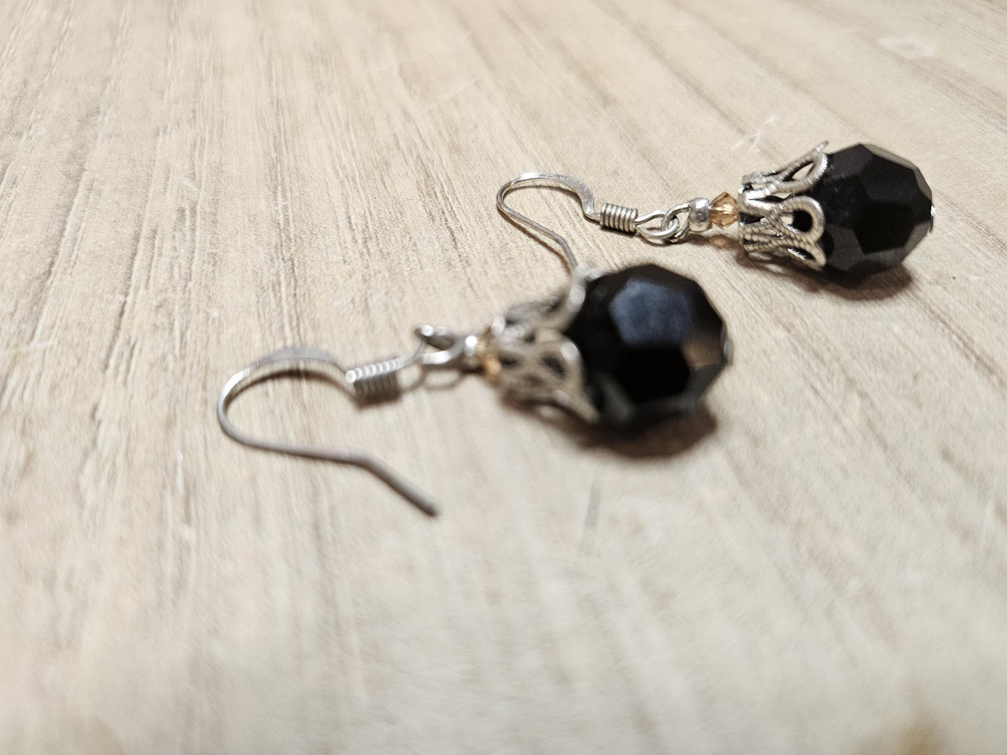 Small silver earrings and blue glass beads