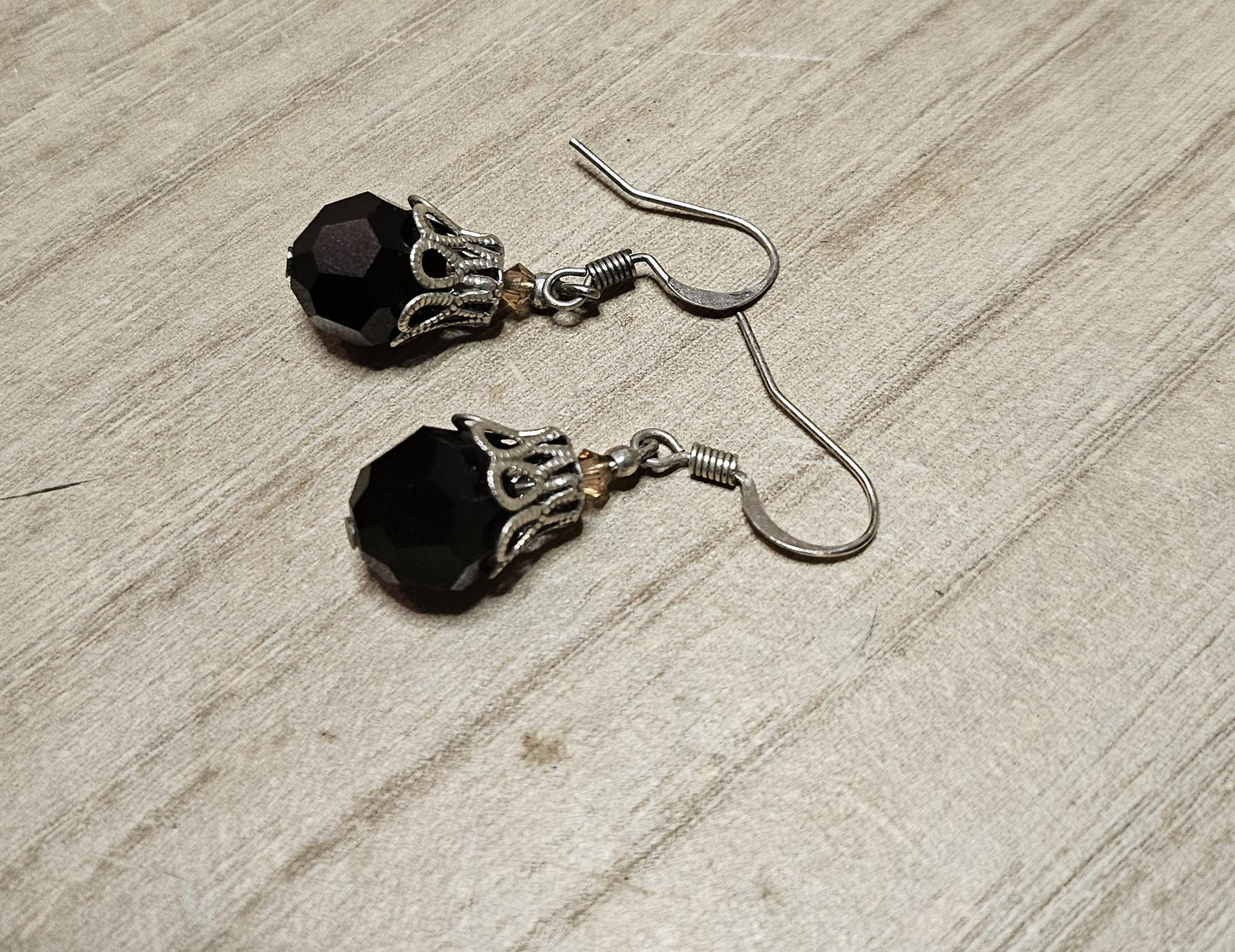 Small silver earrings and blue glass beads