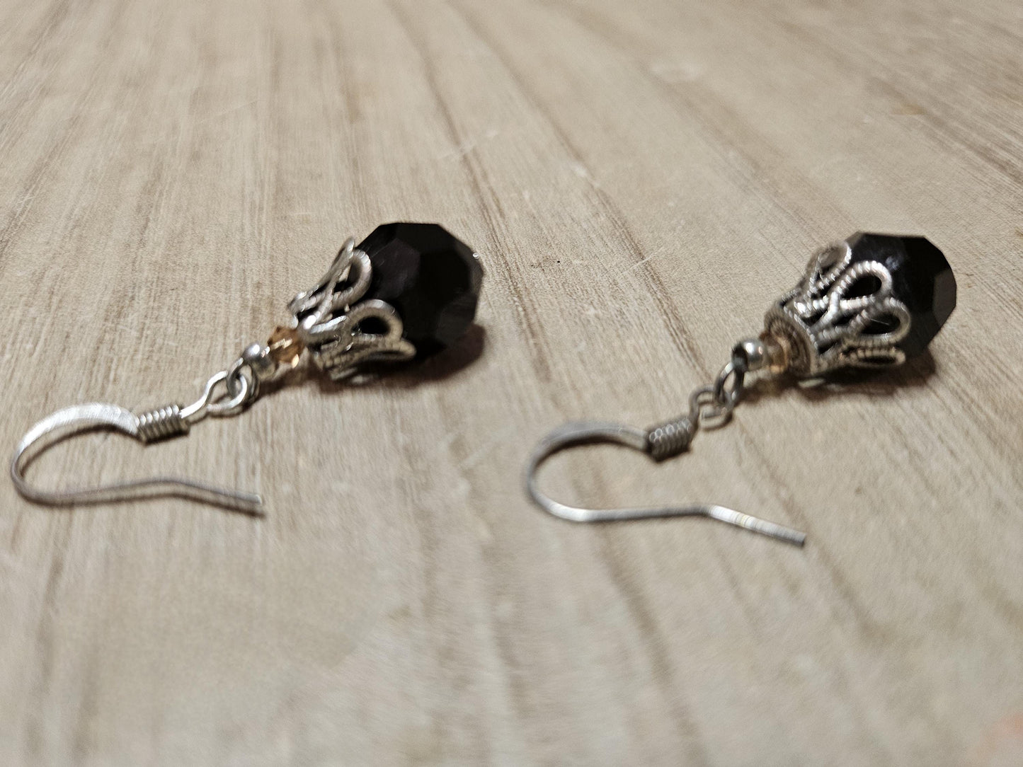 Small silver earrings and blue glass beads